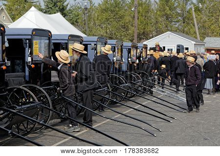 GAP PENNSYLVANIA - MARCH 25 2017: Amish men looking at new and used carriages at the annual "Amish Mud Sale" which benefits Gap Fire Company.