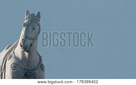 Large horse statue standing tall next to wall