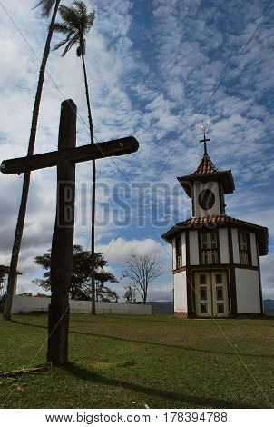 Our Lady of the Rosary Church, located in Milho Verde, Minas Gerais. Mineira Church. Church of the nineteenth century. Blue sky. Church on a hill. Cross and Church.