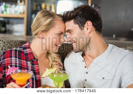 Couple head to head smiling in a bar