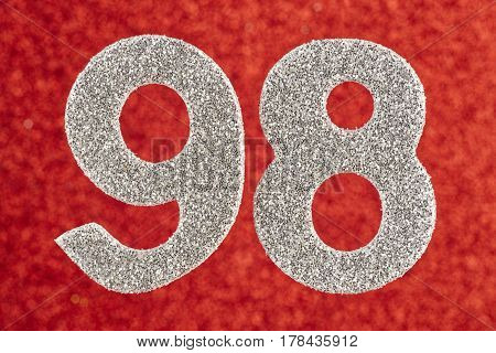 Number ninety-eight silver color over a red background. Anniversary. Horizontal