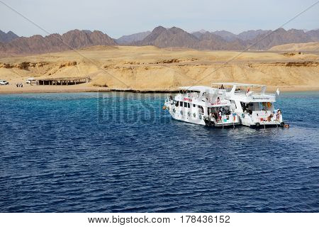 SHARM EL SHEIKH EGYPT - DECEMBER 4: Snorkeling tourists and motor yachts on Red Sea in Ras Muhammad National Park. It is popular tourists destination on December 4 2013 in Sharm el Sheikh Egypt