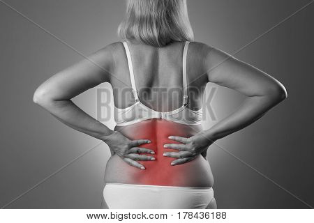 Back pain kidney inflammation ache in woman's body black and white photo with red spots
