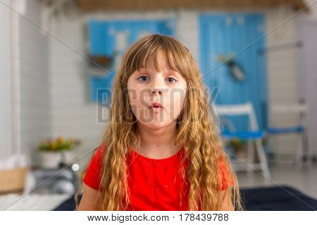 Young girl closeup shows different emotions. Littel girl