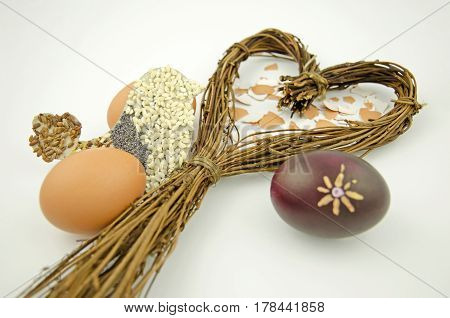 Still life with a heart of willow Easter eggs and bird silhouette isolated on white background
