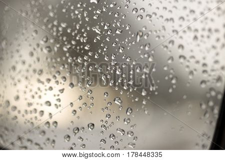 Water droplets on the glass with a blurry background.
