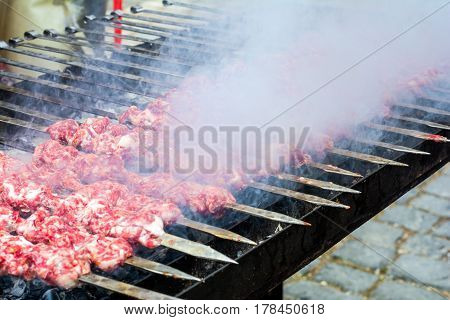 Marinated kebab preparing over charcoal. Selective focus