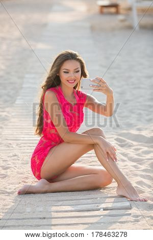 Beautiful girls selfie self photo on beach vacation during summer travel holidays. Posing for camera having fun.