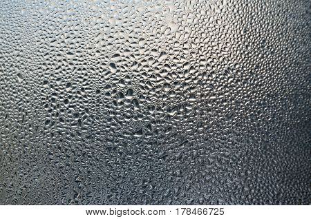 Transparent drop of water on a window pane