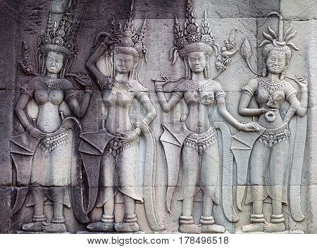 Ancient reliefs with Apsaras at Angkor Wat temple, Cambodia. Angkor Wat was built between 1113 and 1150 by King Suryavarman II.