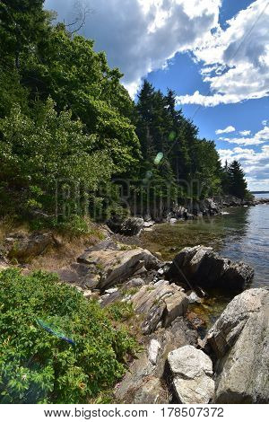 Rock lined shore of an island in Casco Bay Maine.