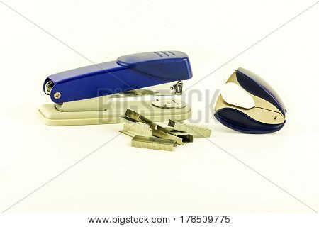 On a white background lie a stapler staples for stapler and anti-stapler