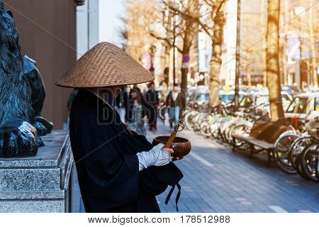Japanese monk praying and asking for donations at Susukino Sapporo Hokkaido Japan