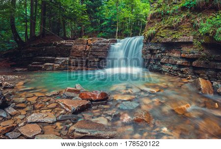 Evening Manyavsky waterfall in Carpathian mountains Ukraine.