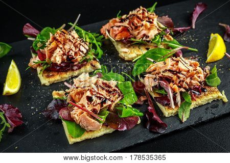 Smoked salmon flakes on salad bed and irish potato slims snacks, appetizers.