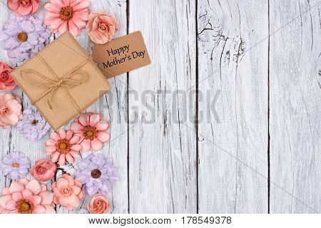 Side Border Of Paper Flowers With Mother's Day Gift Box And Tag Against A Rustic White Wood Backgrou