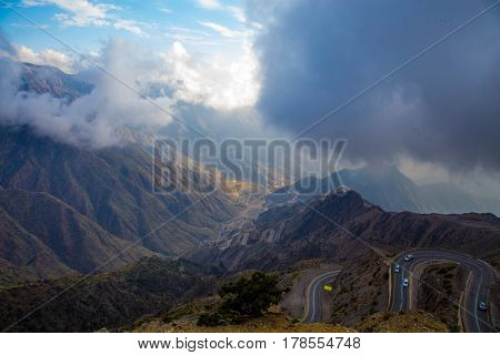 The Sun behind the clouds over mountains