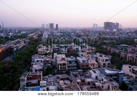 Noida cityscape at night with lights on the buildings and the construction cranes clearly visible