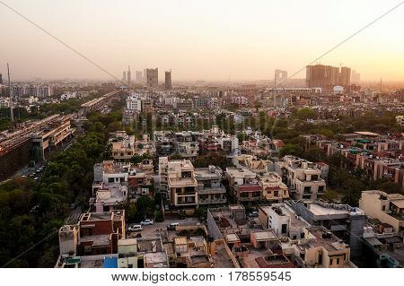 Noida cityscape at dusk with the under construction buildings and golden sunset light