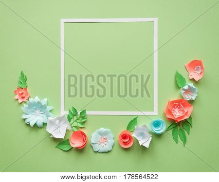 Square Frame With Color Paper Flowers On The Green Background. Flat Lay. Nature Concept