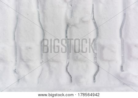 Closeup image of car tracs left in snow background texture