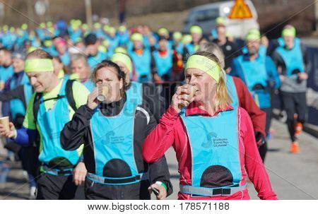STOCKHOLM SWEDEN - MAR 25 2017: Group of runners drinking water in the Stockholm Tunnel Run Citybanan 2017. March 25 2017 in Stockholm Sweden