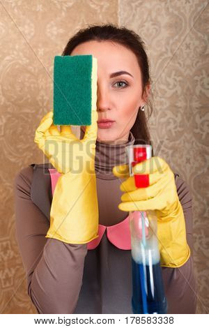 Woman in gloves with sponge and cleaning agent
