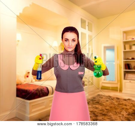 Young housemaid woman in uniform and rubber gloves