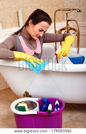 Female cleaning servisce worker sitting in bath