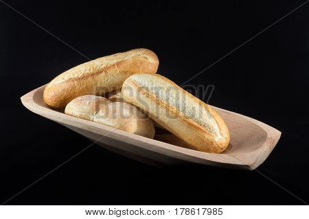Mini French Baguettes On A Rectangular Wood Bowl With Black Background