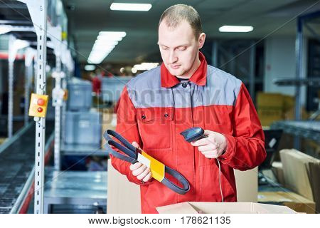 worker with laser barcode scanner at warehouse