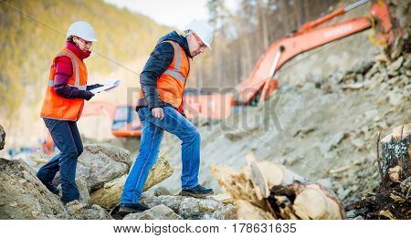 Road engineer workers inspecting road reconstruction and processes
