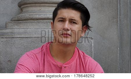 A Hispanic Adult  and Unemotional Serious Man