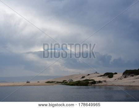 Crokers creek with sand dunes in the background (Belmont - Nine Miles - Beach NSW Australia).