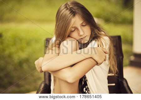 Girl teenager sitting and sleeping in a chair sensual