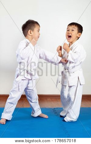 Two boys girls demonstrate martial arts working together. Fighting position active lifestyle practicing fighting techniques