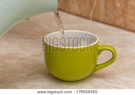 Teapot and cups are prepared for tea drinking at home