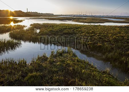 El Rompido lighthouse and marina at sunrise from marshlands Huelva Spain