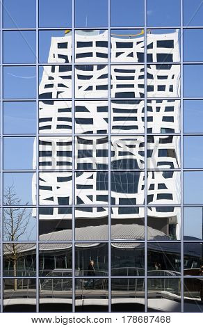utrecht 15march 2017: new city office utrecht seen from footbridge reflected in glass building of rabobank