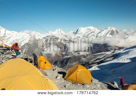 Orange Tents of high Altitude Camp of Mountain Climbers Expedition in Himalaya Nepal in the evening