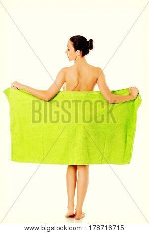 Young beautiful woman after bath full portrait isolated over white.