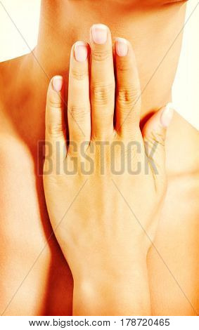 Young woman scratching her neck.
