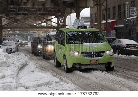 BRONX NEW YORK - MARCH 14: Boro taxi and other autos during snow storm. Taken March 14 2017 in New York.
