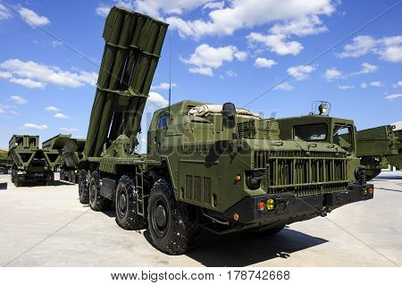 Missile launcher ready to attack on powerful heavy truck, modern military industry, antiaircraft forces, army machines, blue sky and white clouds on background