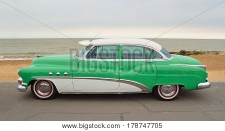 FELIXSTOWE, SUFFOLK, ENGLAND - AUGUST 27, 2016: Classic Green and White Buick Super Eight Moto Car parked on seafront promenade.