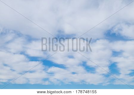 white wispy cirrus and cirrostratus clouds with blue sky
