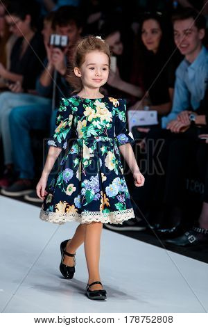 MOSCOW RUSSIA - MARCH 15 2017: Model walk runway for ALISIA FIORI catwalk at Fall-Winter 2017-2018 at Mercedes-Benz Fashion Week Russia. Kid's fashion. Fashion Time Designers.