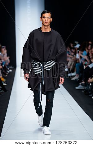 MOSCOW RUSSIA - MARCH 15 2017: Model walk runway for DESIGNER NIKOLAY LEGENDA catwalk at Fall-Winter 2017-2018 at Mercedes-Benz Fashion Week Russia. Men's fashion.