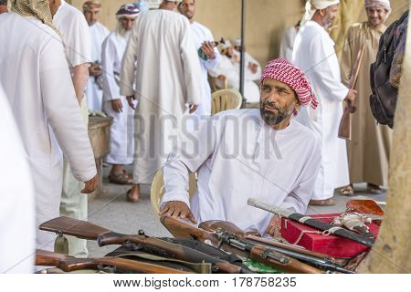 Nizwa Oma 24th March 2017: omani men selling guns at Nizwa market