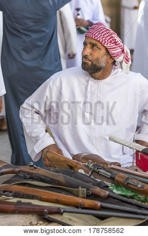 Nizwa Oma 24th March 2017: omani men selling guns at Nizwa market